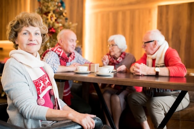 A heartwarming scene of the 90-year-old woman sitting at a table, surrounded by a group of homeless individuals. They are smiling and engaged in friendly conversation, creating a sense of camaraderie and mutual respect.
