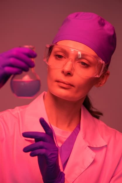 A close-up, emotive shot of the US scientist in their lab, illuminated by the soft glow of research equipment. They are looking directly at the camera with a hopeful, determined expression, surrounded by scientific instruments and data displays.