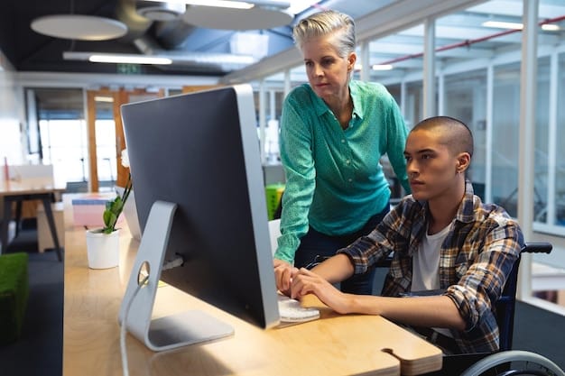 A close-up shot of an employee with a disability working at a computer, showcasing assistive technology tailored to their specific needs. The focus is on the individual's concentration and engagement in the task.