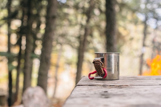 A shot of a bear-resistant food canister in use at a campsite in a US National Forest. The canister is properly sealed and placed away from the tent, according to guidelines for bear safety.