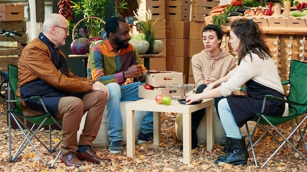 A group of homeless individuals, guided by a US veteran and volunteers, participate in a job skills workshop. They are learning resume writing and interview techniques.