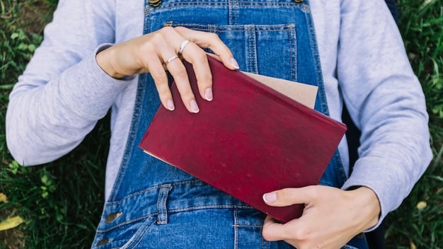 A close-up shot of a young woman's hands holding a book. The hands are calloused but clean, and the book is well-worn, suggesting frequent use. This symbolizes the importance of education and literacy in overcoming adversity.