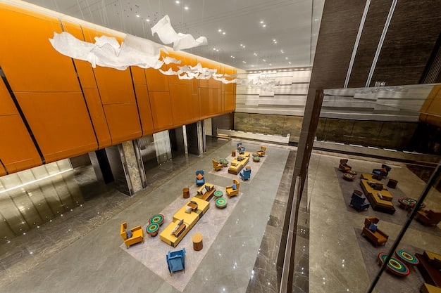 Interior shot of a revitalized factory. The space is well-lit and modern, with workers operating advanced machinery. There are signs of sustainable practices, such as recycling bins and energy-efficient lighting.