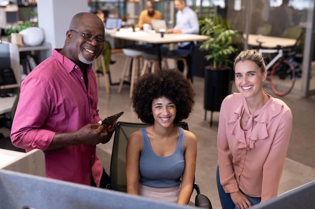 A group of diverse employees smiling and working together in a modern office space. The atmosphere is collaborative and positive.