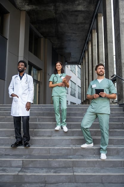 A diverse group of doctors and nurses stand together in a busy urban clinic, representing the collaborative effort required to deliver healthcare to underserved communities. The clinic environment is bustling with activity.