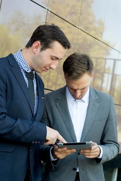 A financial advisor with a freelance client reviewing investment charts on a tablet, conveying a sense of professional guidance and data-driven decision-making.