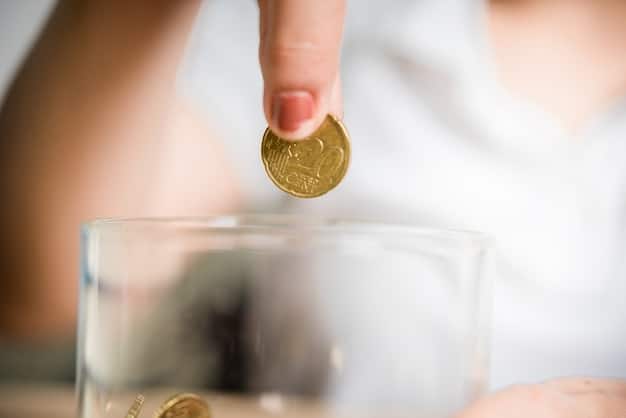 A close-up of a hand placing a coin into a transparent piggy bank, with a blurred background of financial graphs and calculators, symbolizing focused, intentional saving.