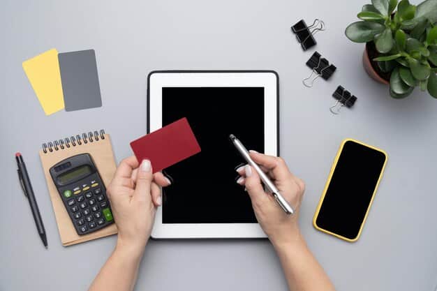 A close-up of a hand holding a credit card, with a financial calculator and documents in the background, illustrating financial planning.