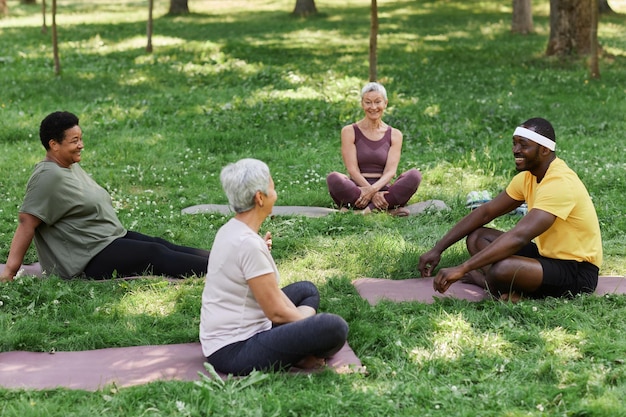 A vibrant, diverse group of US adults engaged in light physical activity outdoors, like yoga in a park, or a brisk walk, emphasizing collective well-being and natural settings.