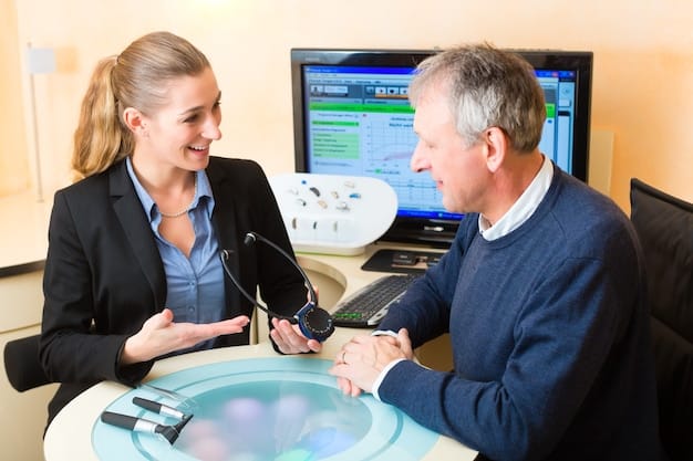 A professional health insurance agent is explaining different plan types (HMO, PPO, EPO, POS) to a couple seated at a table, pointing to a diagram or chart. The couple is attentively listening and asking questions about their options.