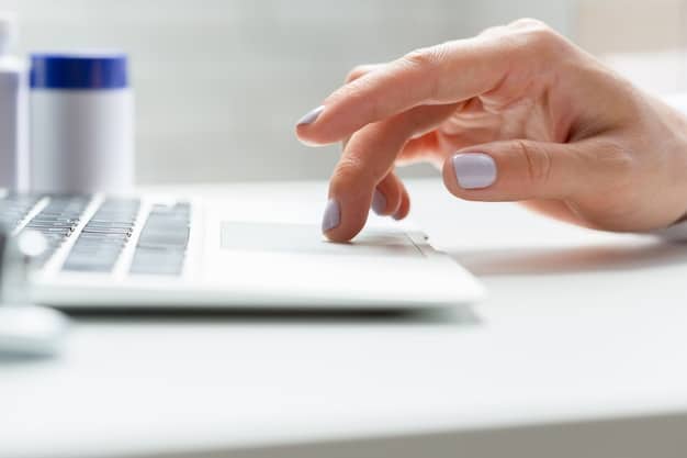 A close-up of hands typing on a laptop, with a FAFSA form visible on the screen, emphasizing the digital application process for financial aid.