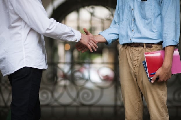 A policy maker shaking hands with a vocational school director, with students in the background, symbolizing government support and partnership for educational development.