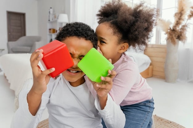 Two US children, one Black and one Hispanic, smiling and sharing building blocks in a preschool classroom, demonstrating cooperation and diverse interaction.