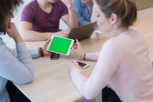 A group of students engaged in a lively debate during a mock stock market game, displaying their virtual portfolios on tablets.