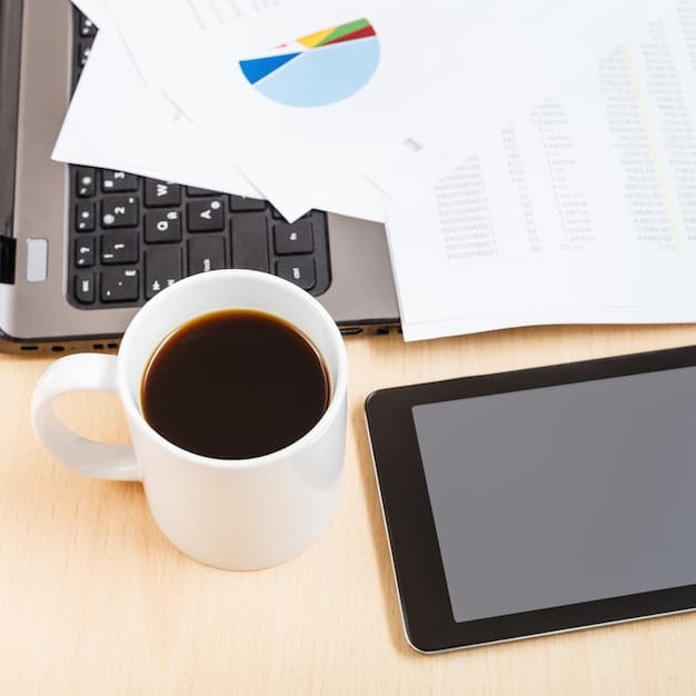 A calculator and tax form sitting on a desk next to a cup of coffee and a pen. The image is focused on tax preparation and financial calculation, relating to maximizing tax refunds for future investments.