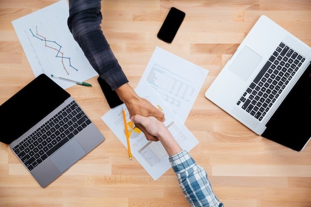 Two hands shaking over a table with financial documents, symbolizing partnership and collaborative financial planning. A graph showing steady growth is subtly visible in the background.