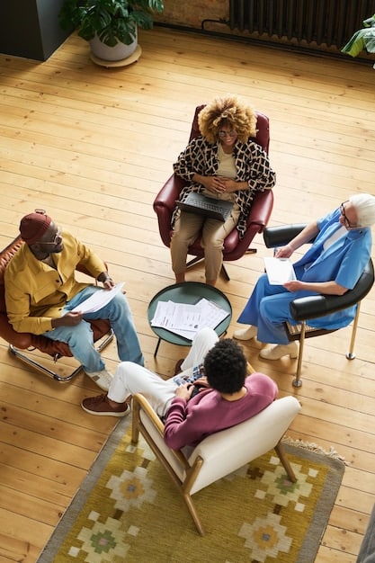 A vibrant photograph showcasing a community support group meeting. A diverse group of people sits in a circle, some holding hands, with a facilitator leading the discussion. The atmosphere is supportive and hopeful, symbolizing the importance of community in overcoming the challenges of the opioid crisis. Demonstrates an Understanding the Opioid Crisis: New Strategies for Pain Management in the US.