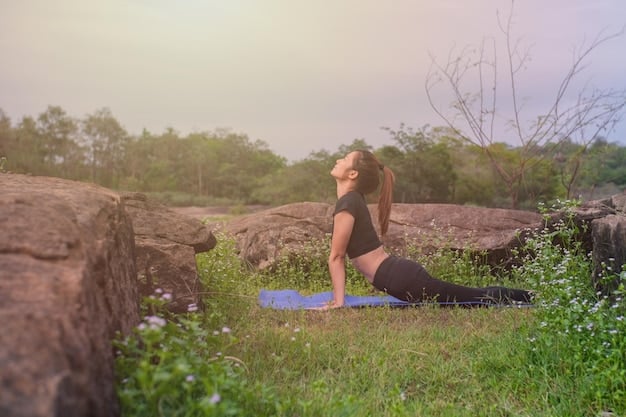 A person practicing yoga outdoors in a serene, natural setting, with a focus on their peaceful expression and the graceful poses they are performing. The background features lush greenery and soft lighting, conveying tranquility and mental clarity, which supports the new research: the link between exercise and brain health.
