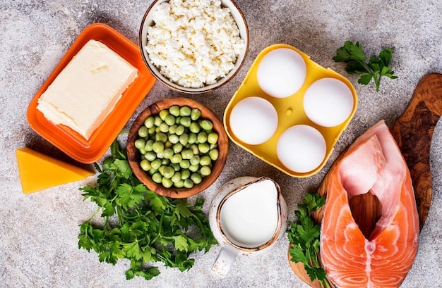 An image showing various Vitamin D rich foods like fatty fish, egg yolks, fortified milk, and mushrooms arranged on a wooden table in a bright, natural light setting. The arrangement communicates that these foods are good sources of Vitamin D. Include vegetables to make it attractive.