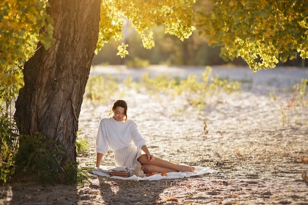 A person taking a deep breath outdoors in a natural setting, with trees and sunlight in the background, symbolizing relaxation and stress relief. Focus on the person's calm expression and posture.