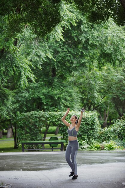 A person is shown exercising outdoors, jogging in a park with green trees and a clear sky in the background. The image conveys a sense of health and vitality.