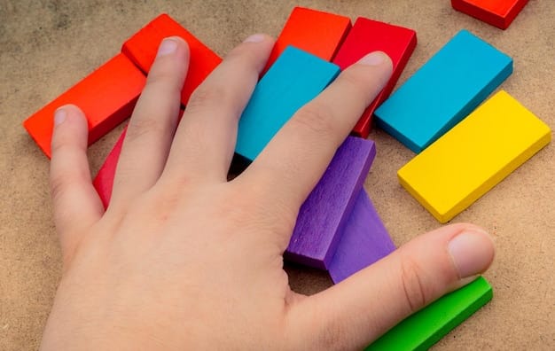 A close-up shot of a young child's hands carefully manipulating colorful building blocks, demonstrating fine motor skills and cognitive development. The background features other children engaged in similar activities.
