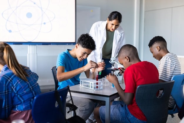 A dedicated science teacher explaining a complex physics concept to an attentive group of high school students using interactive digital displays and hands-on experiments.