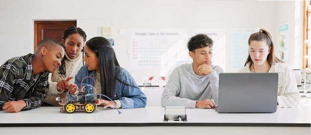 Students in a modern classroom collaborating on a coding project on laptops, with a robotics kit visible in the foreground, demonstrating practical application of STEM principles.