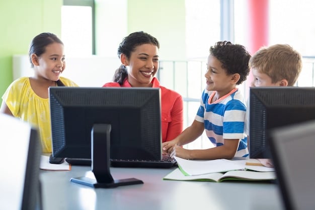 A diverse group of elementary school children engaged in a computer-based standardized test, with a teacher observing quietly in the background.